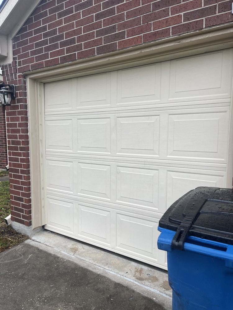 White garage door on brick home